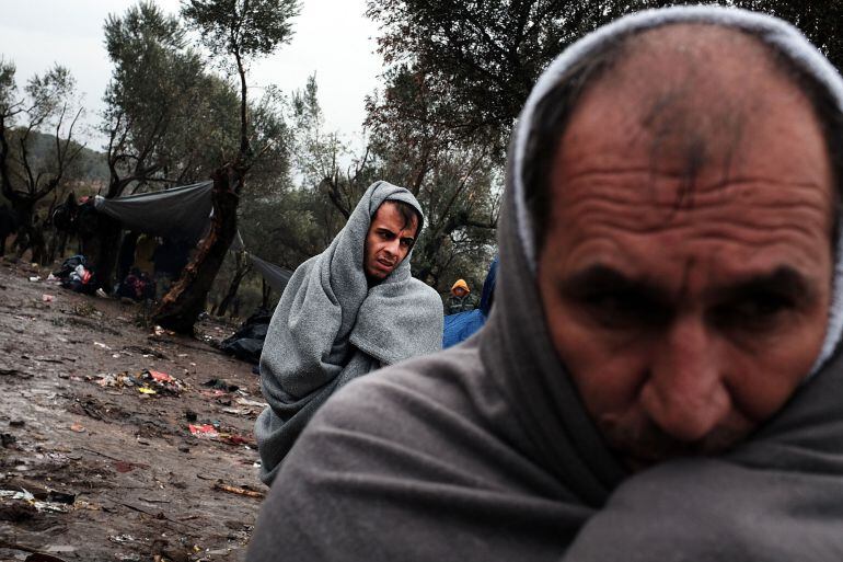 MITILINI, GREECE - OCTOBER 23: Migrants try to stay warm at the increasingly overwhelmed Moria camp on the island of Lesbos on October 23, 2015 in Mitilini, Greece. Dozens of rafts and boats are still making the journey daily as thousands flee conflict in