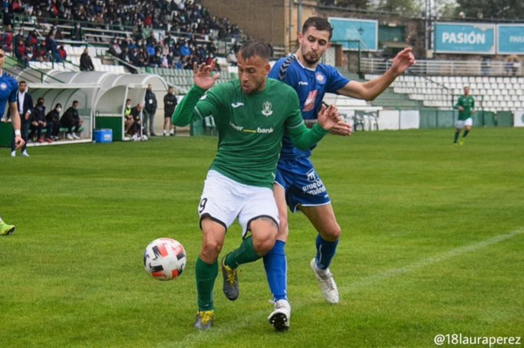 Rubén Moreno conduce el balón con la oposición de un rival