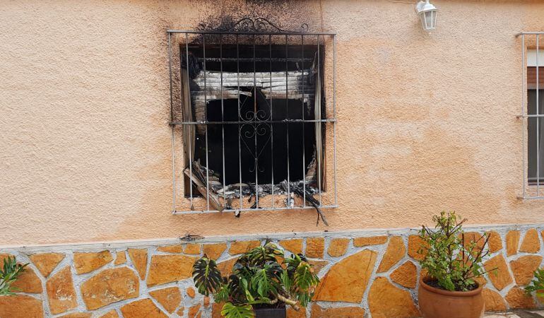 Estado en que ha quedado la vivienda unifamiliar en la partida El Moralet, tras la extinción del incendio declarado hoy en ella.