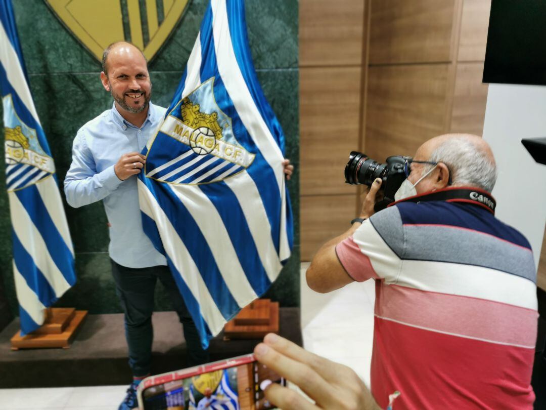 José Alberto López posa con la bandera del Málaga tras su concentración