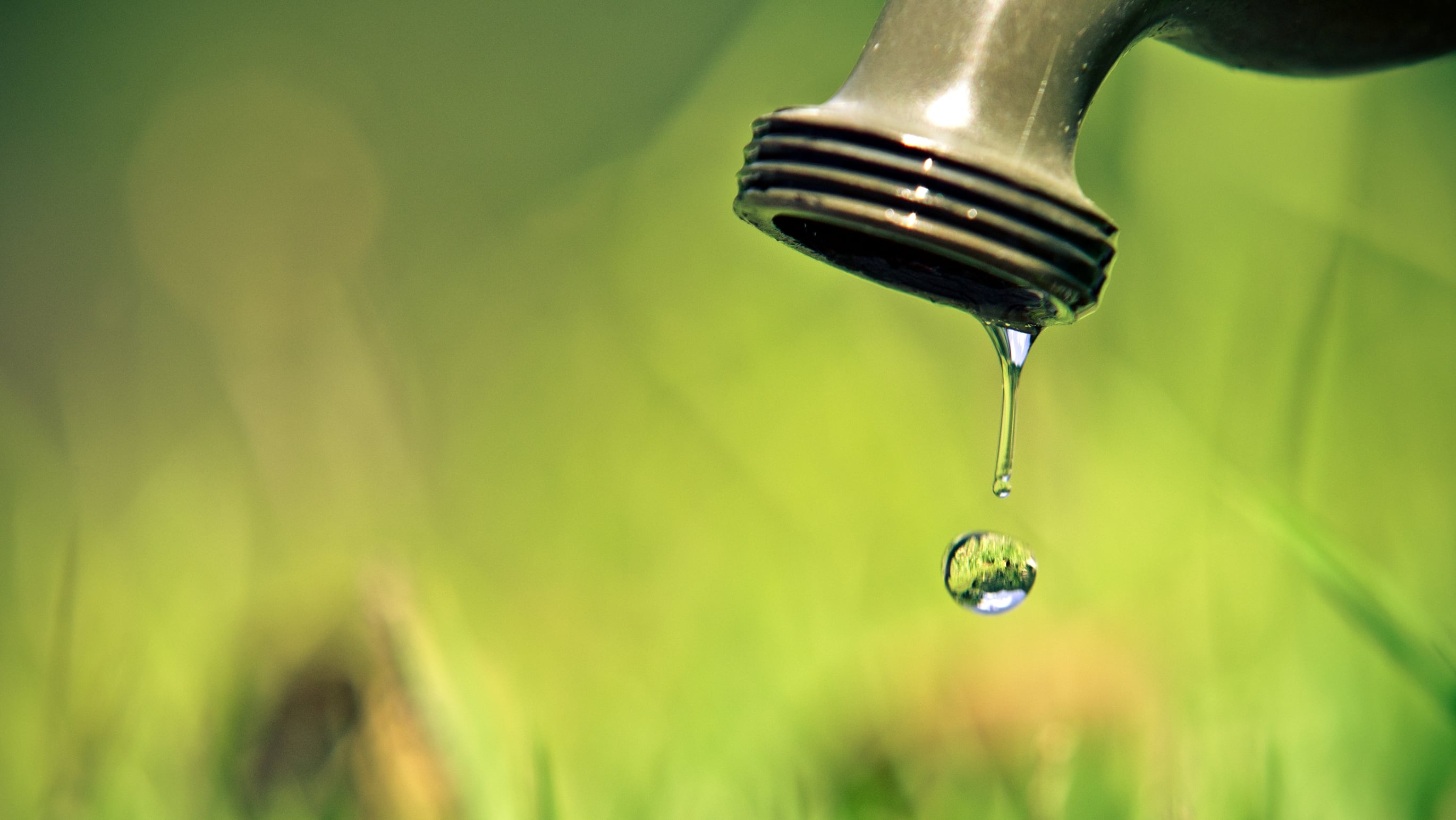 Gota de agua brotando de un grifo