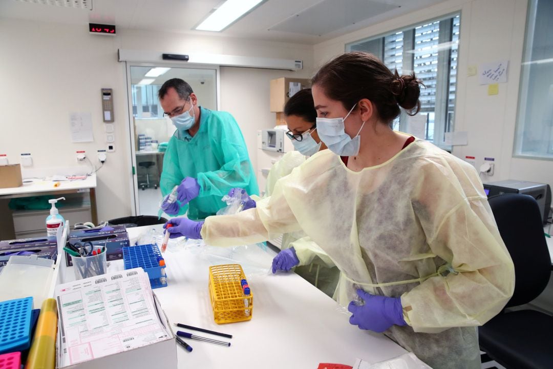 Staff members work as media visit the Microbiology Laboratory of the University Hospital (CHUV) during the coronavirus disease (COVID-19) 