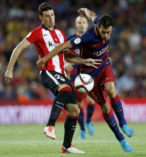 Aduriz y Busquets pugnan por un balón.