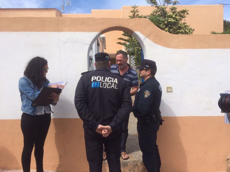 Los agentes en la entrada de la casa con el propietario