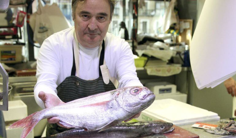 Un pescadero de Bilbao muestra un besugo, uno de los productos de consumo estrella de la Navidad.