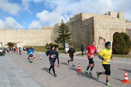 Corredores a su paso por la calle Palacio en la zona del arco de San Basilio al fondo