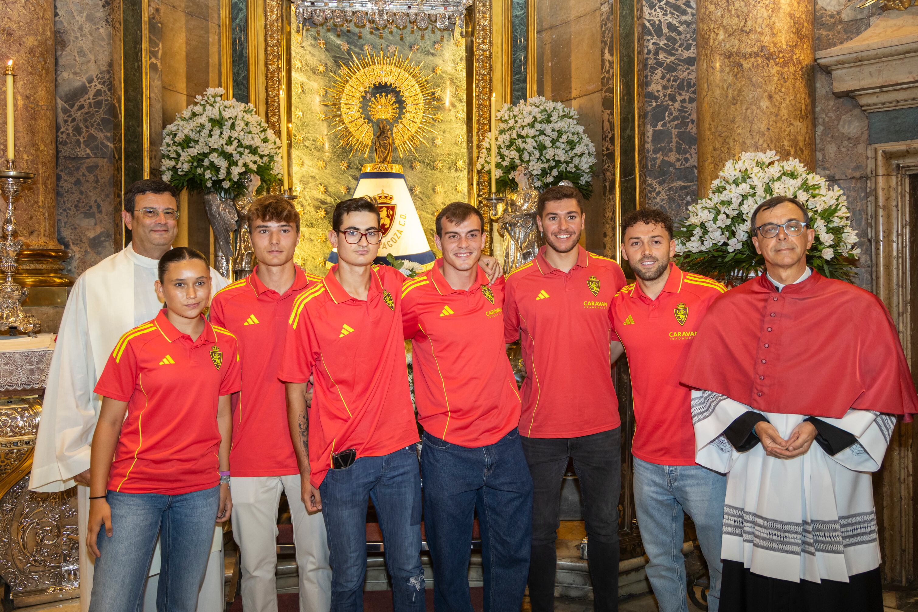 ZARAGOZA, 13/08/2025.- Los capitanes del Zaragoza, Francho (4i) y Keidi Bare (6i) posan junto con los capitanes de las categorías inferiores y categoría femenina durante la tradicional ofrenda de flores a la virgen del Pilar antes del comienzo de la nueva temporada. EFE/Toni Galán
