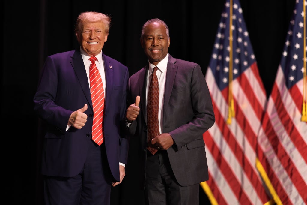 Ben Carson y Donald Trump posan juntos durante un acto público.