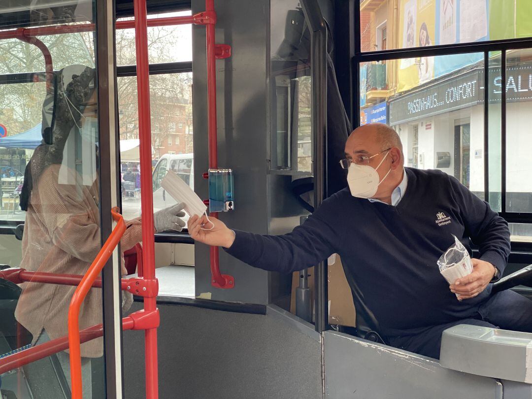 El conductor de l&#039;autobús urbà repartint mascaretes