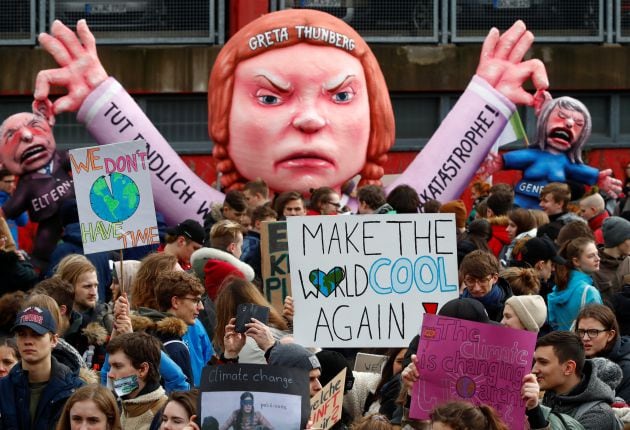 Students use a carnival float depicting Swedish environmental campaigner Greta Thunberg during a strike from school to demand action on climate change at the town hall square of Duesseldorf, Germany, March 15, 2019