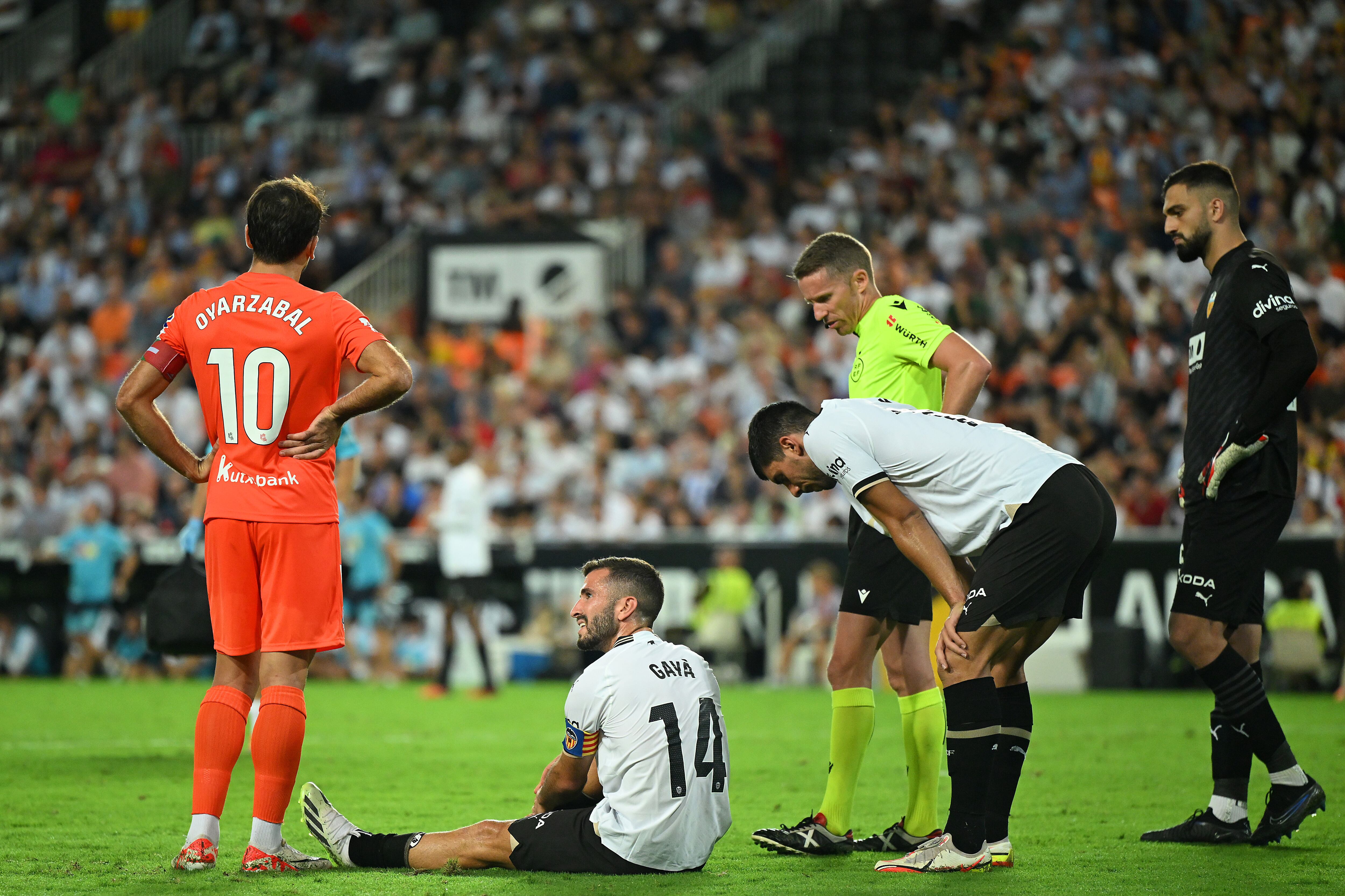 VALENCIA, SPAIN - SEPTEMBER 27: Jose Luis Gaya of Valencia goes down with an injury during the LaLiga EA Sports match between Valencia CF and Real Sociedad at Estadio Mestalla on September 27, 2023 in Valencia, Spain. (Photo by David Ramos/Getty Images)