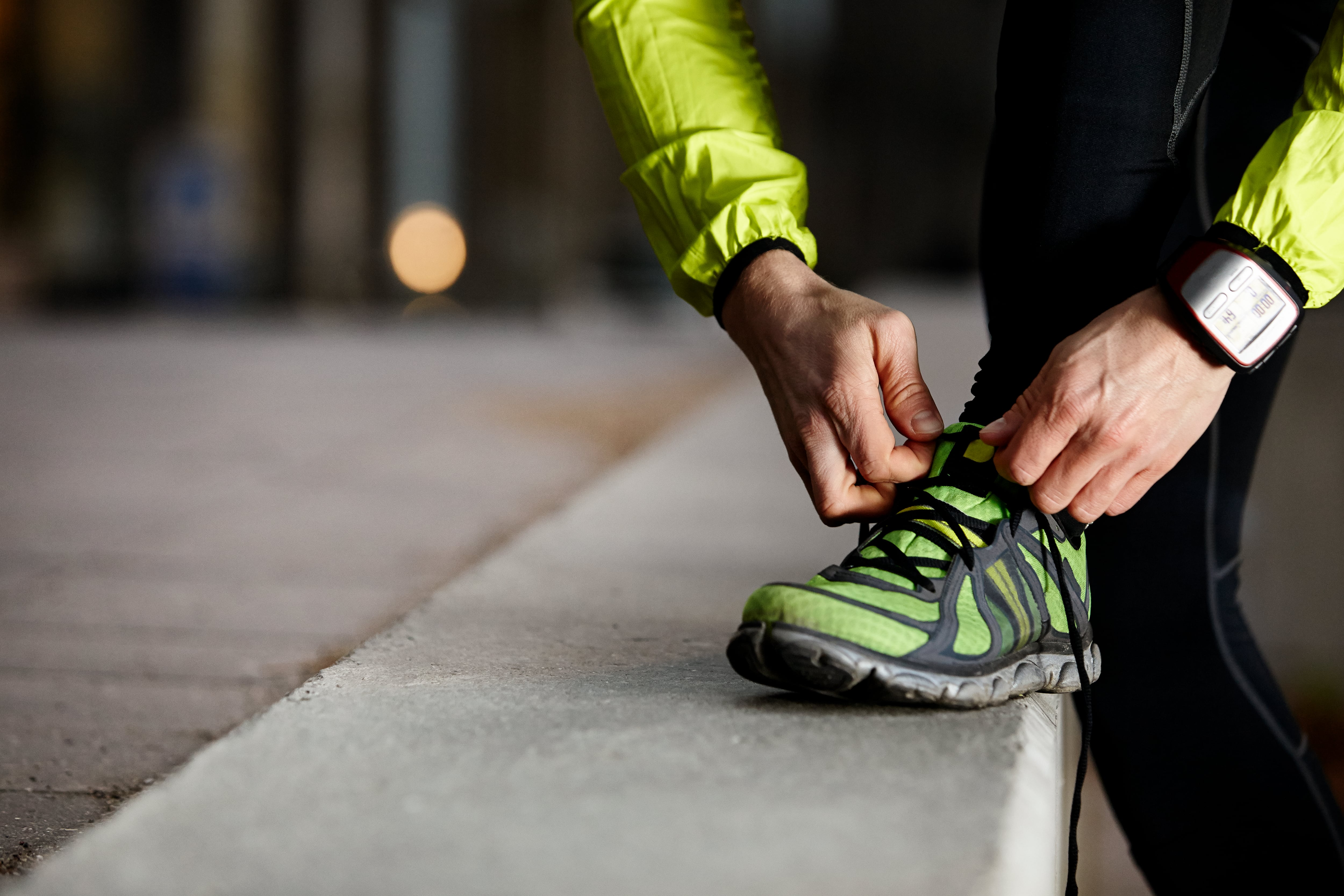 Un atleta se ajusta las zapatillas antes de salir a correr