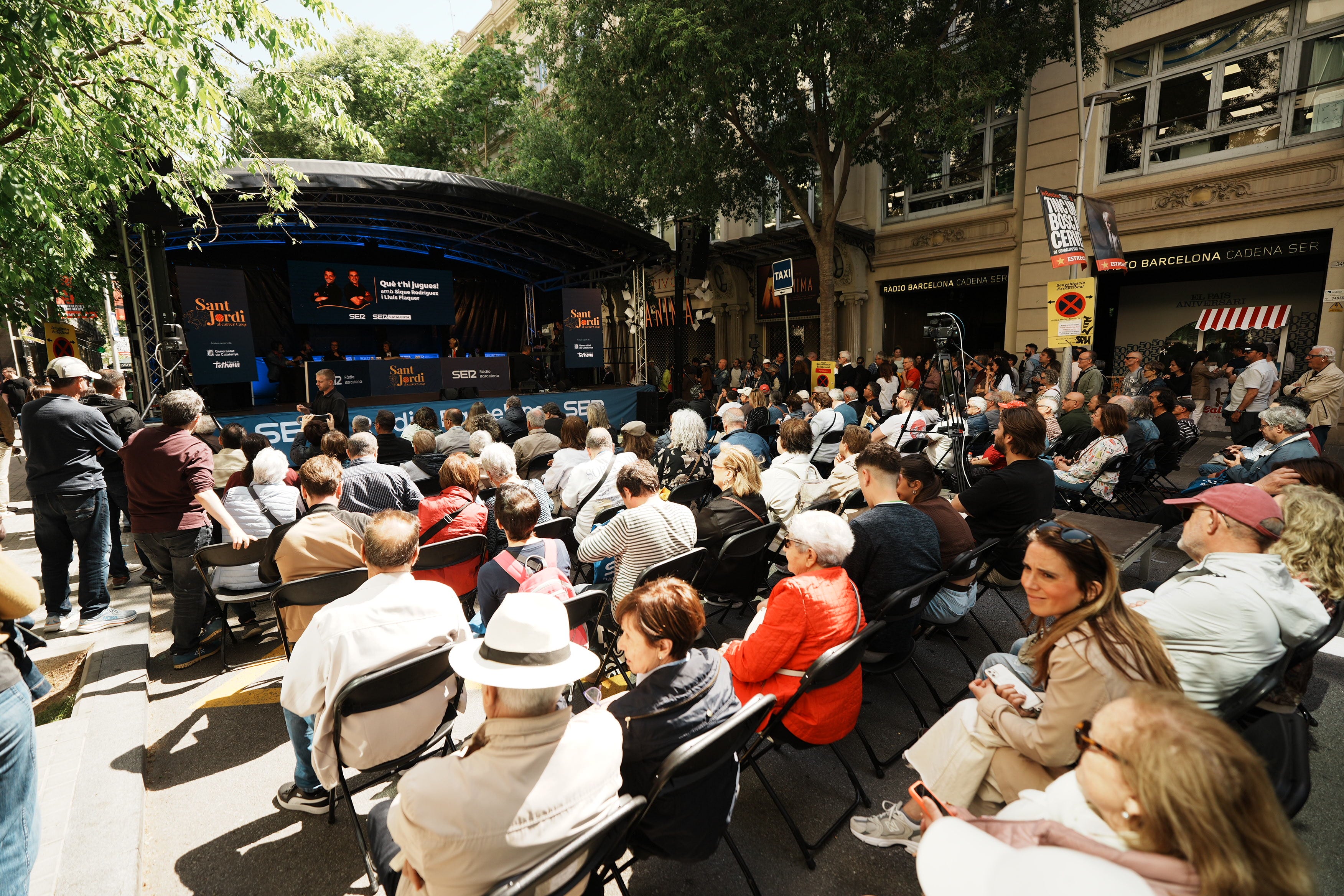 El carrer de Casp, davant de Ràdio Barcelona, ple de públic gaudint del Sant Jordi al carrer de SER Catalunya
