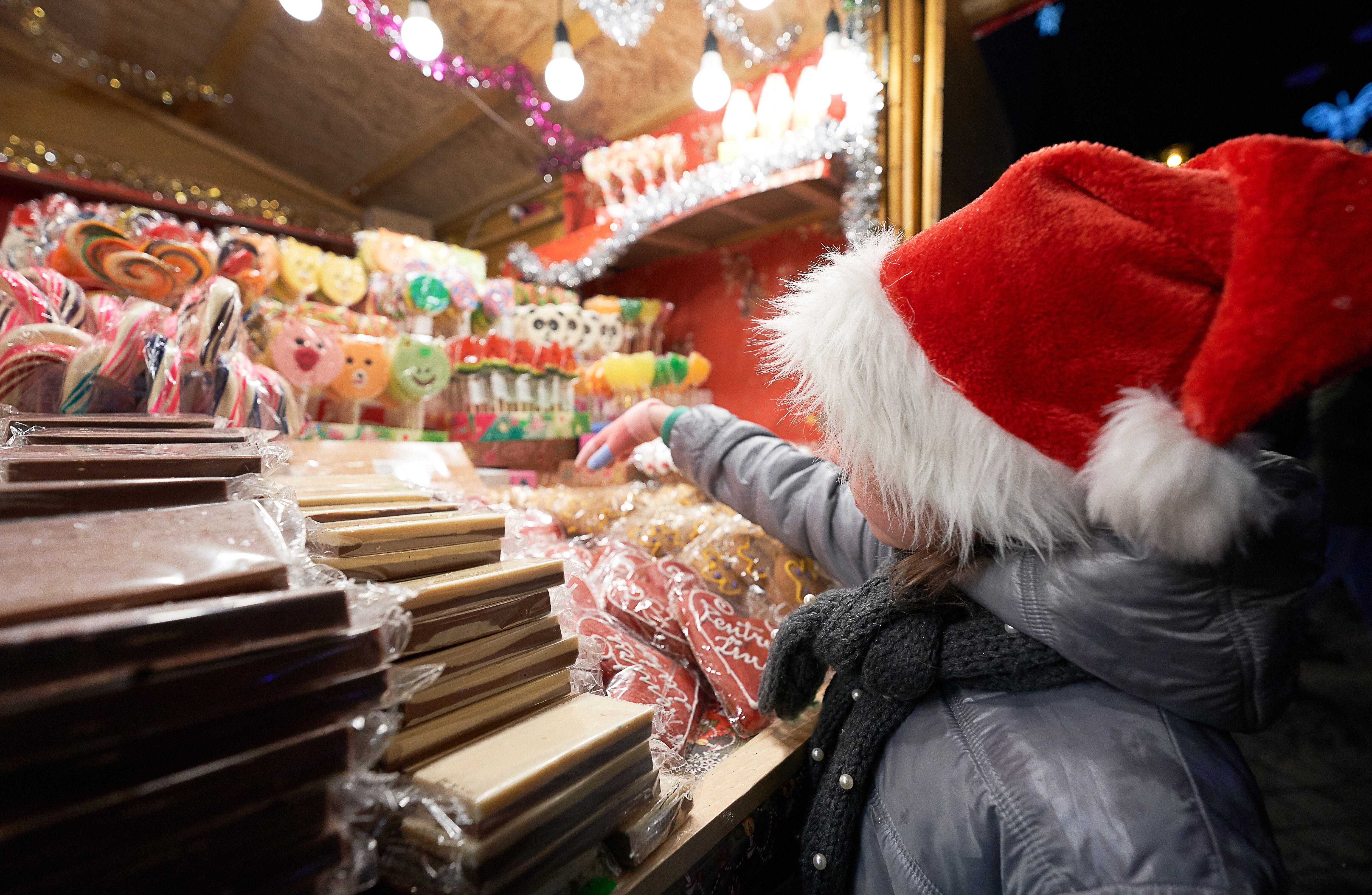 Color image depicting a huge selection of candy and sweets on display and for sale on a market stall at a Christmas market in Sibiu, a city in the Transylvania region of Romania.