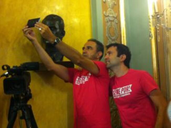 Els dos regidors de Crida-CUP fent-se un selfie abans de començar el ple amb el bust del rei Felip VI