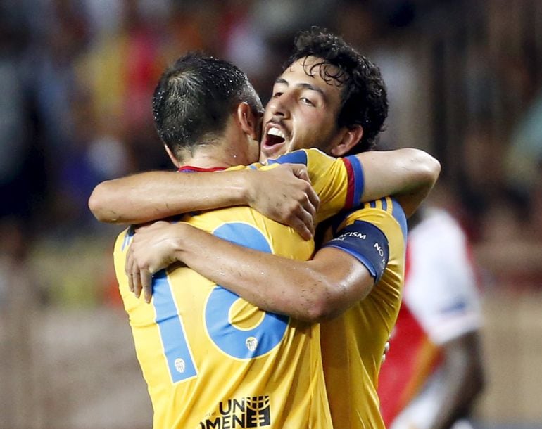 Valencia&#039;s captain Daniel Parejo (R) hugs teammate Javie Fuego after defeating Monaco during their Champions League play-off second leg soccer match at the Louis II stadium in Monaco August 25, 2015.  REUTERS/Eric Gaillard