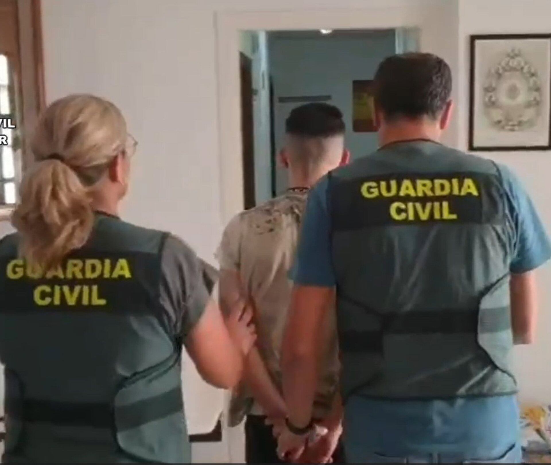 Agentes de la Guardia Civil conducen a uno de los detenidos