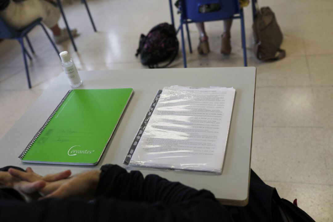 Cuadernos en una mesa de un aula de un colegio. 