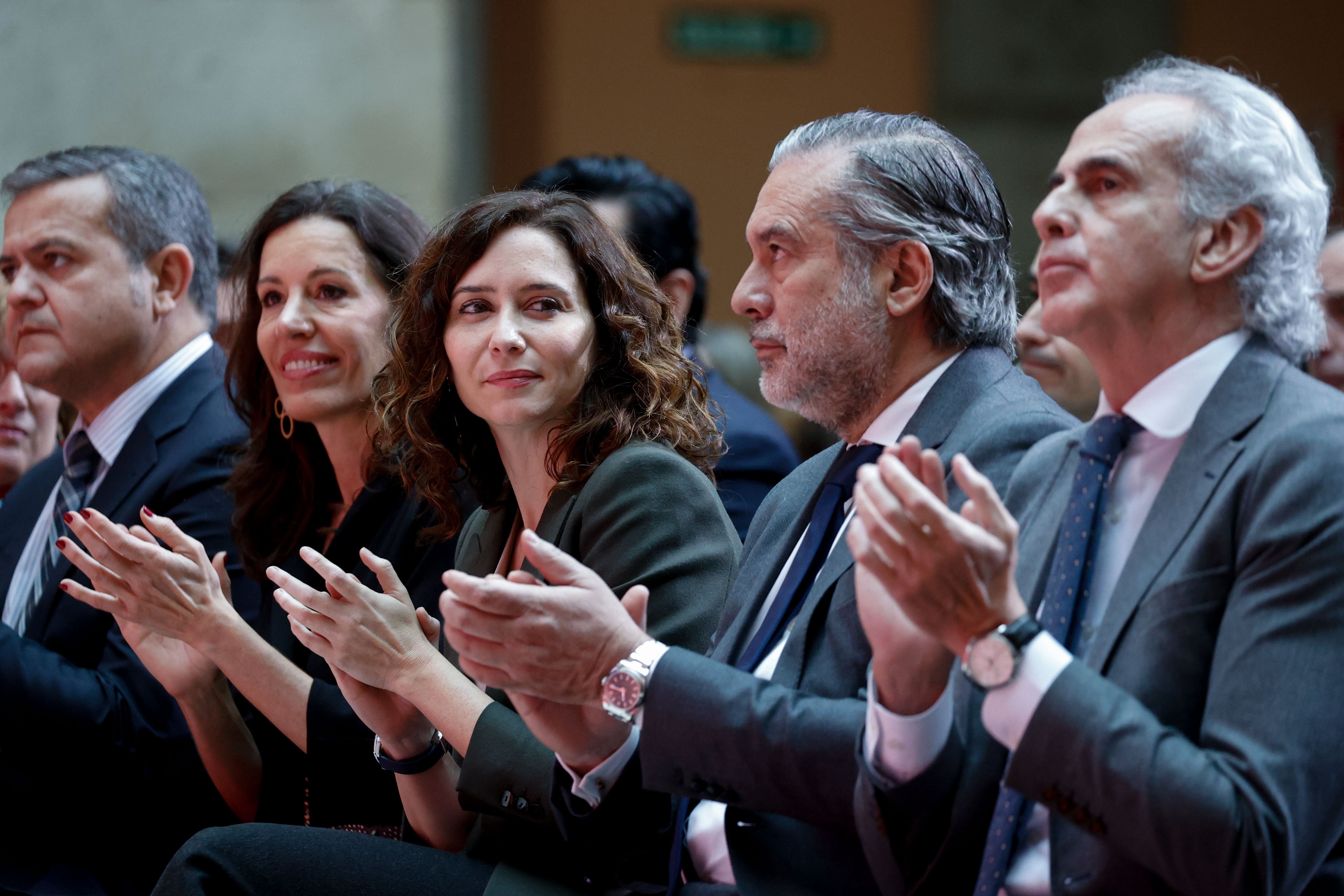 La presidenta de la Comunidad de Madrid, Isabel Díaz Ayuso (c) junto con sus consejeros de Justicia e Interior, Enrique López (2d) y Sanidad, Enrique Ruiz Escudero (d) asiste al acto de conmemoración del XXV aniversario de la creación del Centro de Emergencias Madrid 112 celebrado en la Casa de Correos.