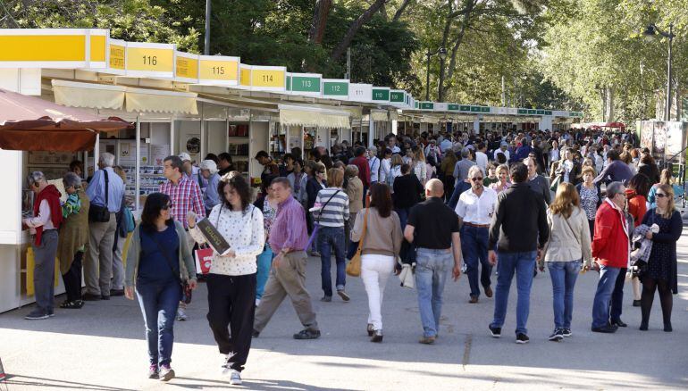 Varias personas recorren algunos puestos de la Feria del Libro de Madrid que se celebra estos días en el Parque del Retiro. EFE. 