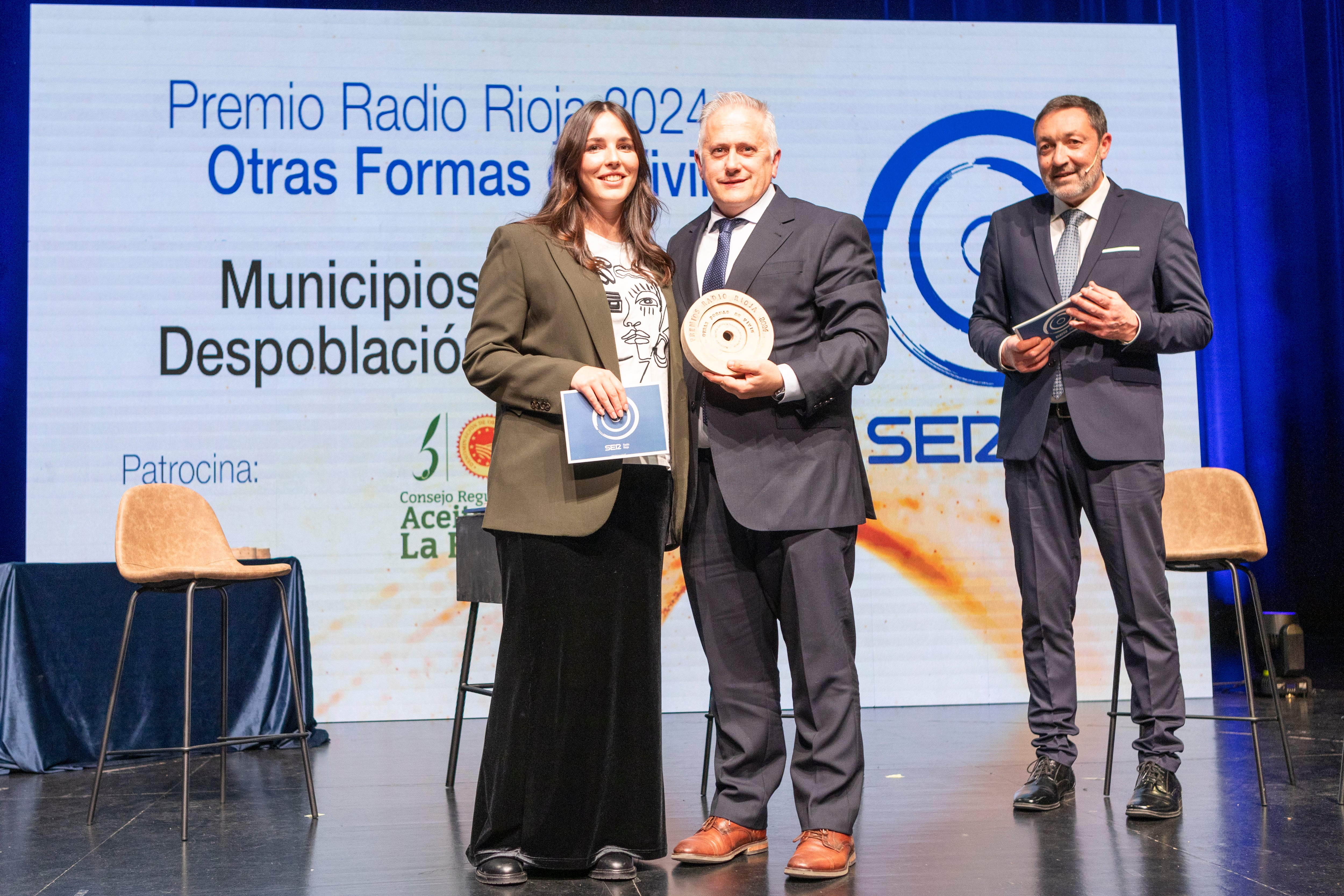 Clara Espinosa, presidenta de la DOP Aceite de La Rioja entregando el Premio Radio Rioja 2024 &#039;Otras formas de vivir&#039; a Jorge Loyo, presidente de la Federación Riojana de Municipios de La Rioja