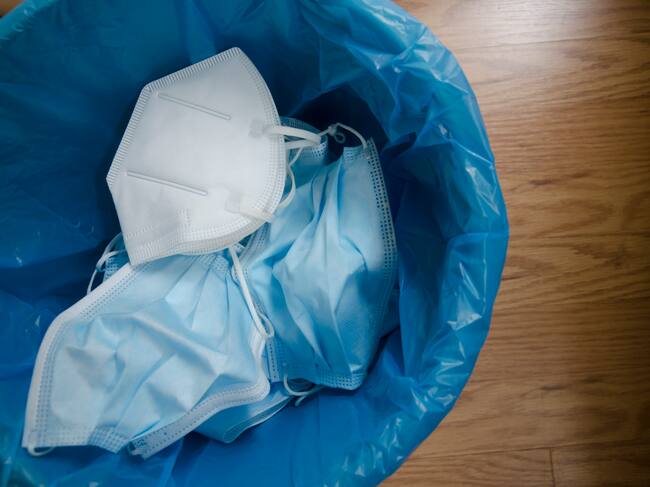 Varias mascarillas tiradas a la basura para poder ser recicladas