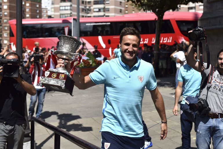 El capitán del Athletic de Bilbao, Carlos Gurpegui, muestra la Supercopa de España ganada ayer en el partido frente al FC Barcelona antes de realizar hoy la ofrenda a la Virgen de Begoña, patrona de Bilbao, con lo que se han iniciado los actos de homenaje