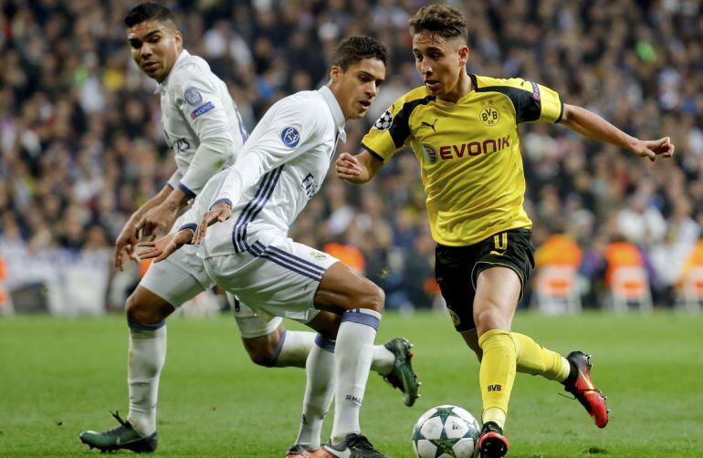 Varane intenta robar un balón al jugador del Borussia Emre Mor