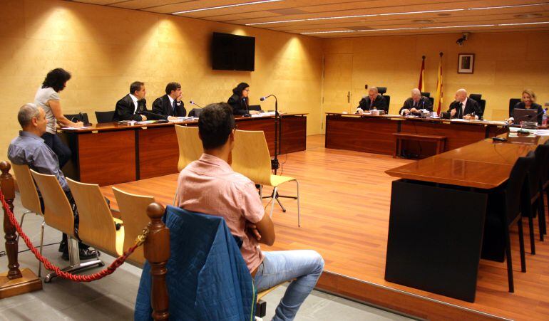 L&#039;agressor condemnat, en primer pla. El policia, a l&#039;esquerra. 