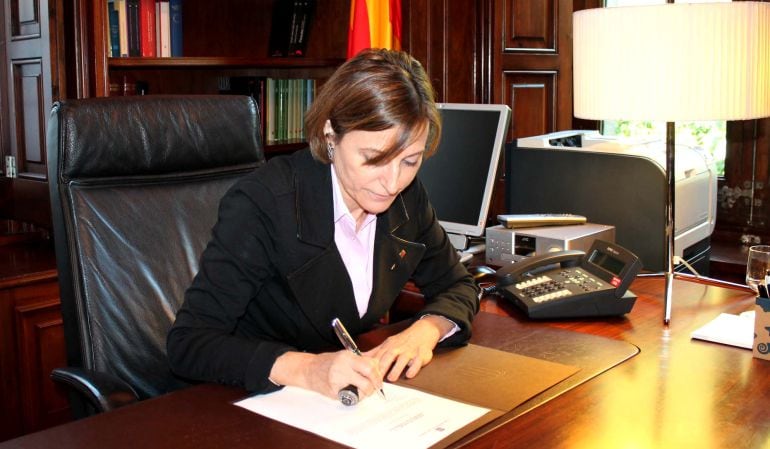 La presidenta del Parlament, Carme Forcadell, signant la proposta d'Artur Mas com a candidat a ser investit president de la Generalitat i la fotografia de la proposta signada.
