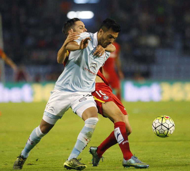 El defensa argentino del Celta de Vigo, Gustavo Daniel Cabral (i), disputa el balón con el centrocampista del Getafe, Pablo Sarabia, durante el partido del pasado domingo.