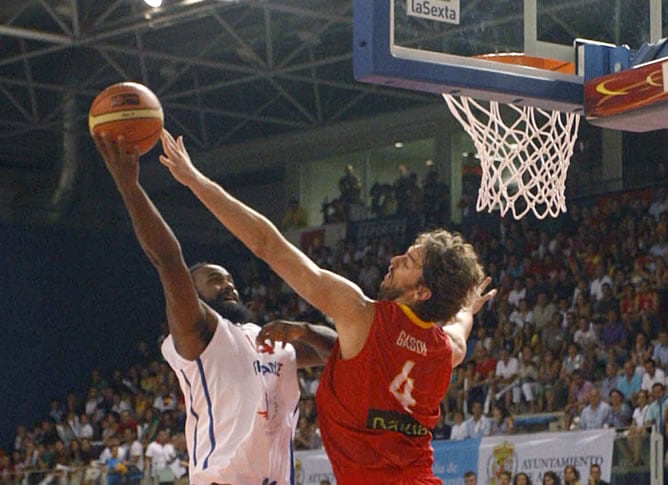 El pivot de la seleccion española de baloncesto Pau Gasol (2i) intenta taponar un lanzamiento del pivot de la seleccion francesa Ronny Turiaf (i) durante el partido amistoso que disputan ambas selecciones en el Palacio de los Juegos Mediterraneos de Almer