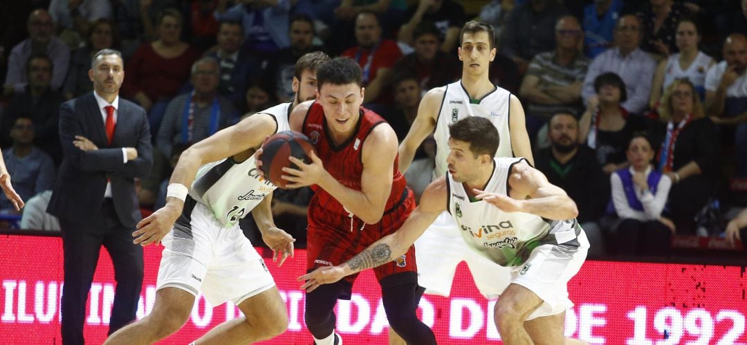 &#039;Jota&#039; Cuspinera, en segundo plano, observa al fuenlabreño &#039;Pako&#039; Cruz y el verdinegro Nico Laprovittola durante el duelo de este domingo en el Pabellón Fernando Martín.