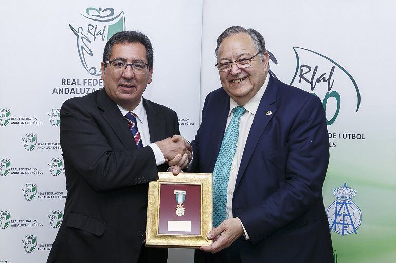 Antonio Pulido, presidente de la Fundación Cajasol, ha recibido de la mano del presidente de la Real Federación Andaluza de Fútbol, Eduardo Herrera, la Medalla del Centenario de la RFAF