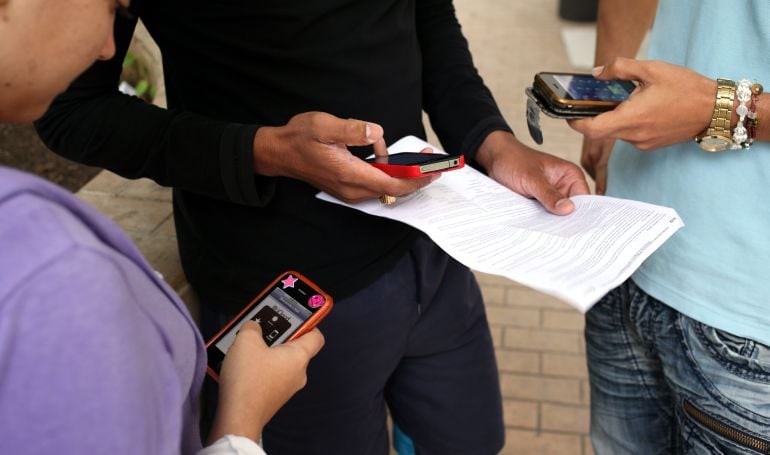 Joves amb els seus telèfons mòvils