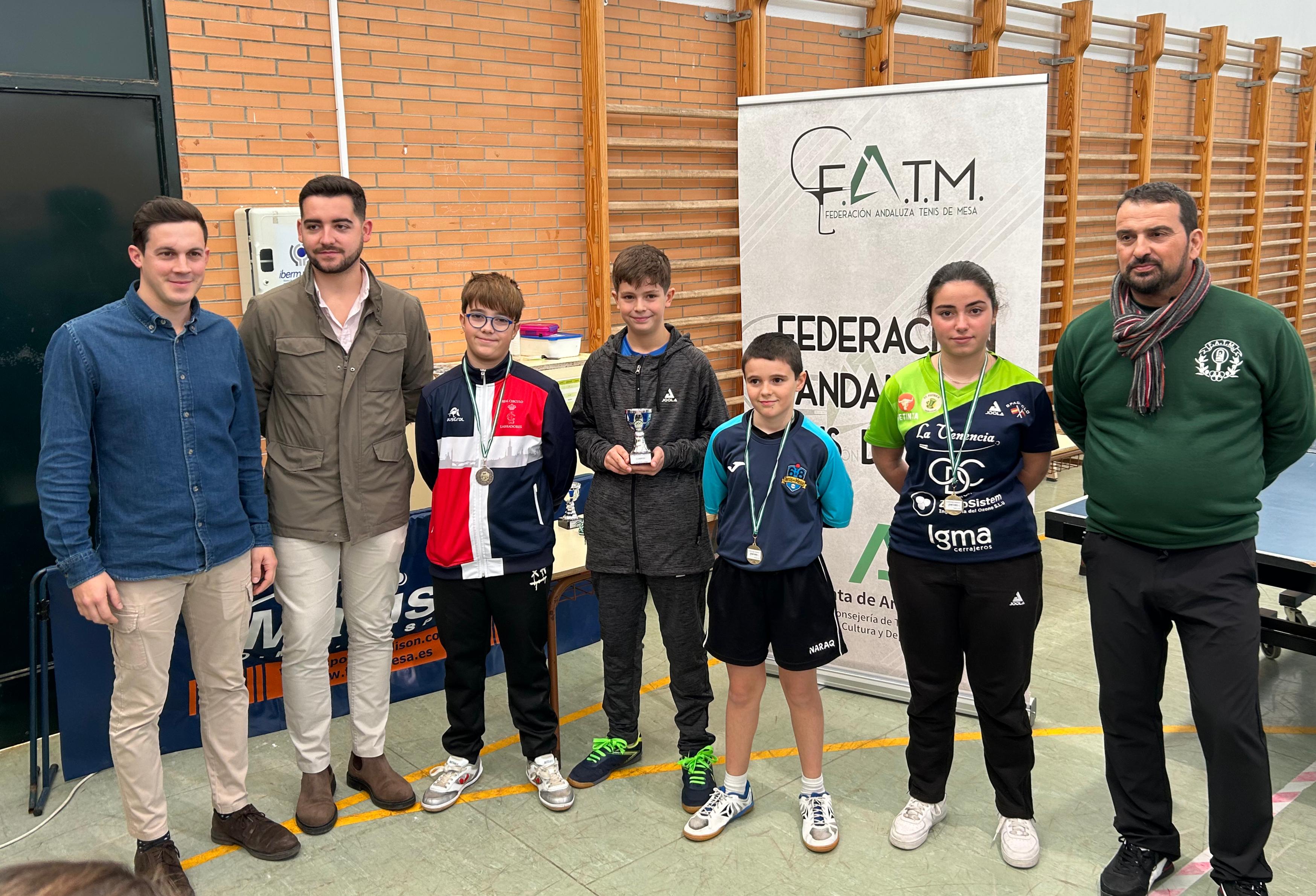 Javier Galán, en el centro, posa con su trofeo de campeón en categoría alevín mixta en Carmona