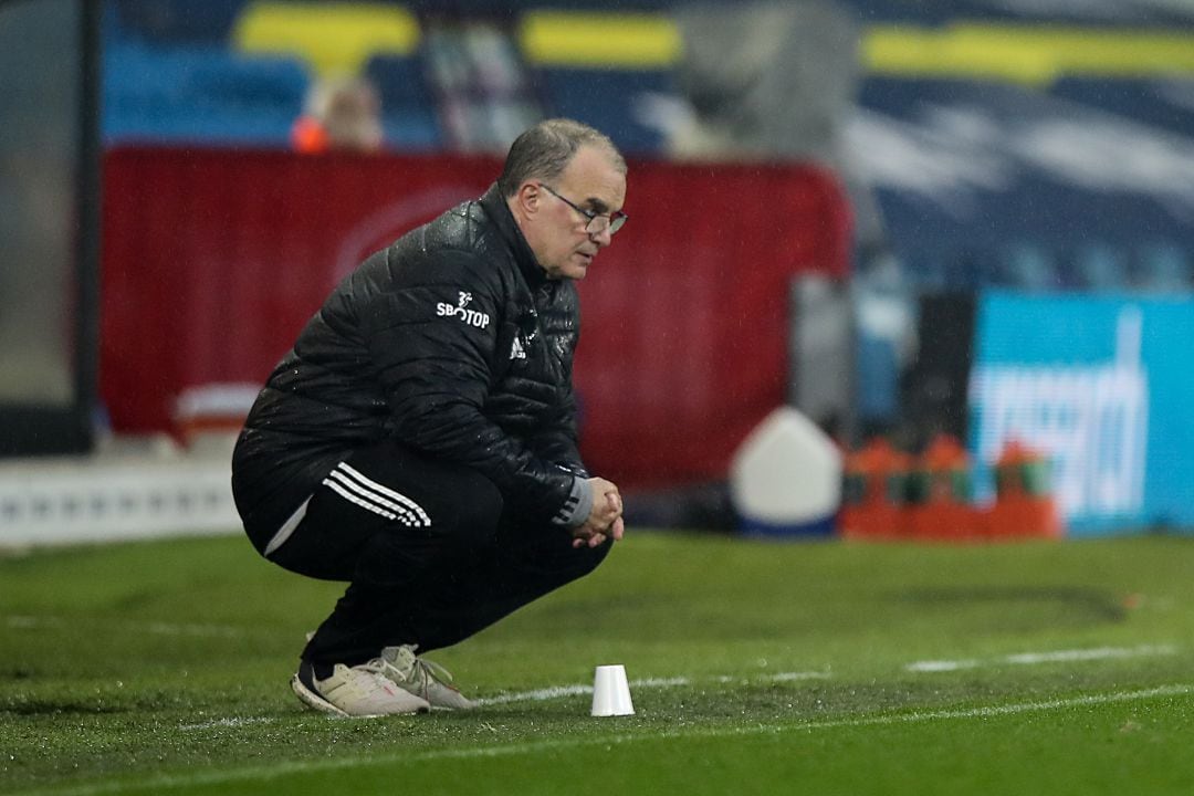 Marcelo Bielsa observa un partido del Leeds United en cuclillas