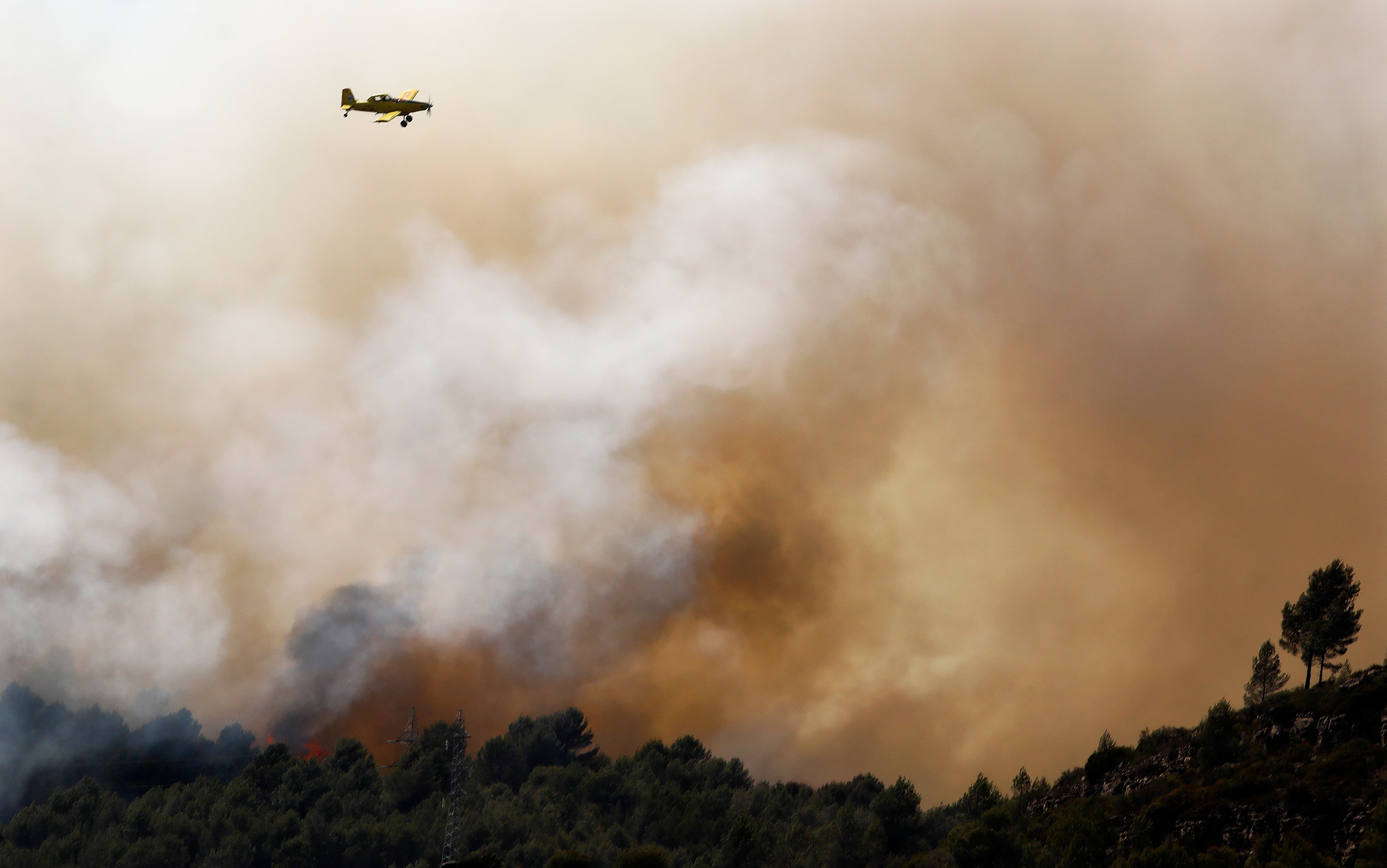 Una avioneta treballa en les tasques d'extinció de l'incendi de El Pont de Vilomara, al Bages