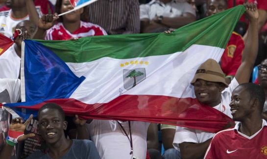 FILE- In this file photo dated Saturday, Nov. 16, 2013, supporters hold national flags of Ecuatorial Guinea before a friendly soccer match between Spain and the host nation of Ecuatorial Guinea, at Malabo Stadium in Malabo, Equatorial Guinea. Equatorial G