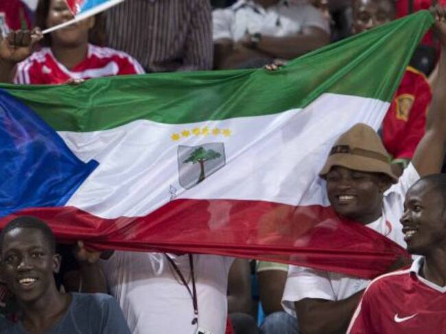 FILE- In this file photo dated Saturday, Nov. 16, 2013, supporters hold national flags of Ecuatorial Guinea before a friendly soccer match between Spain and the host nation of Ecuatorial Guinea, at Malabo Stadium in Malabo, Equatorial Guinea. Equatorial G
