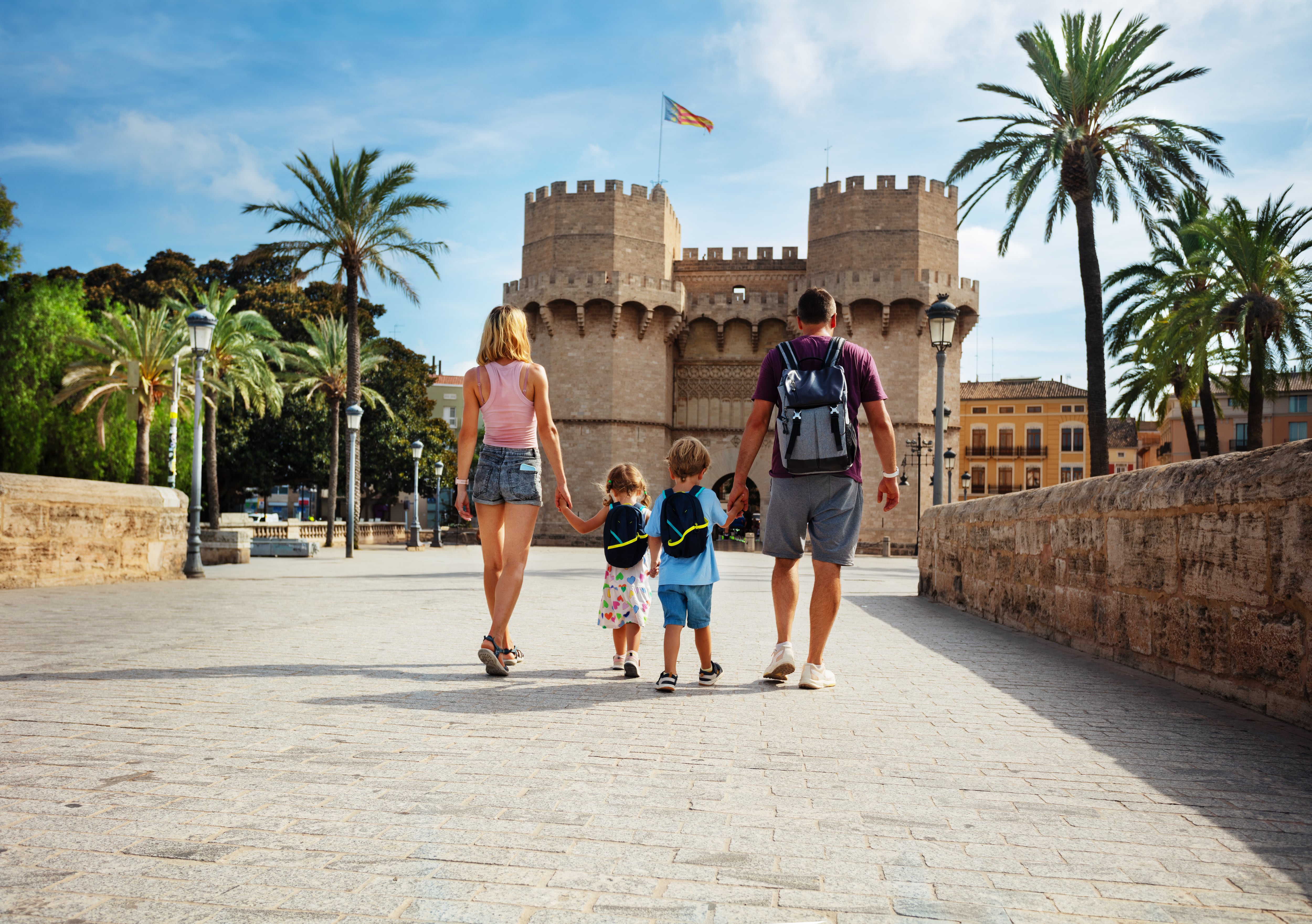 Familia camina por el puente de Serranos de València