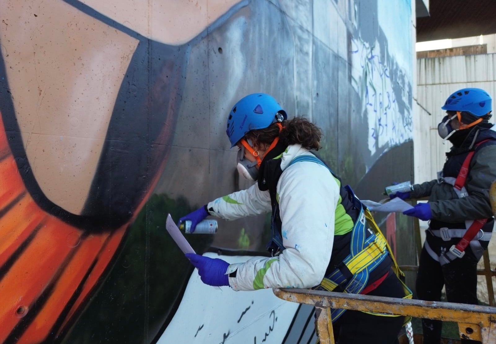 Cristina Domínguez (Crisdose) y Ángel Caballero (Xolaka) durante el proceso de creación del mural.