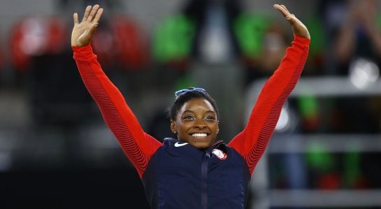 RIO DE JANEIRO, BRAZIL - AUGUST 11: Gold medalist Simone Biles of the United States celebrates on the podium at the medal ceremony for the Women&#039;s Individual All Around on Day 6 of the 2016 Rio Olympics at Rio Olympic Arena on August 11, 2016 in Rio de Ja