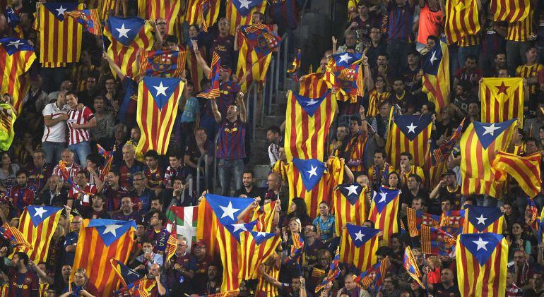 Supporters of Barcelona wave Catalan independentist flags &quot;Estelada&quot; as one also displays a Basque flag prior to the Spanish Copa del Rey (King&#039;s Cup) final football match Athletic Club Bilbao vs FC Barcelona at the Camp Nou stadium in Barcelona on May 30, 2015.   AFP PHOTO/ LLUIS GENE