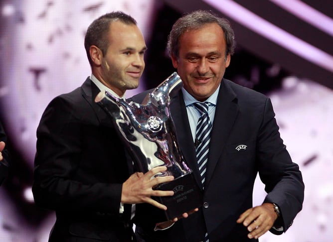 El centrocampista español Andrés Iniesta recibe de manos del presidente de la UEFA, Michel Platini, el Premio UEFA al Mejor Jugador de la campaña 2011/12.