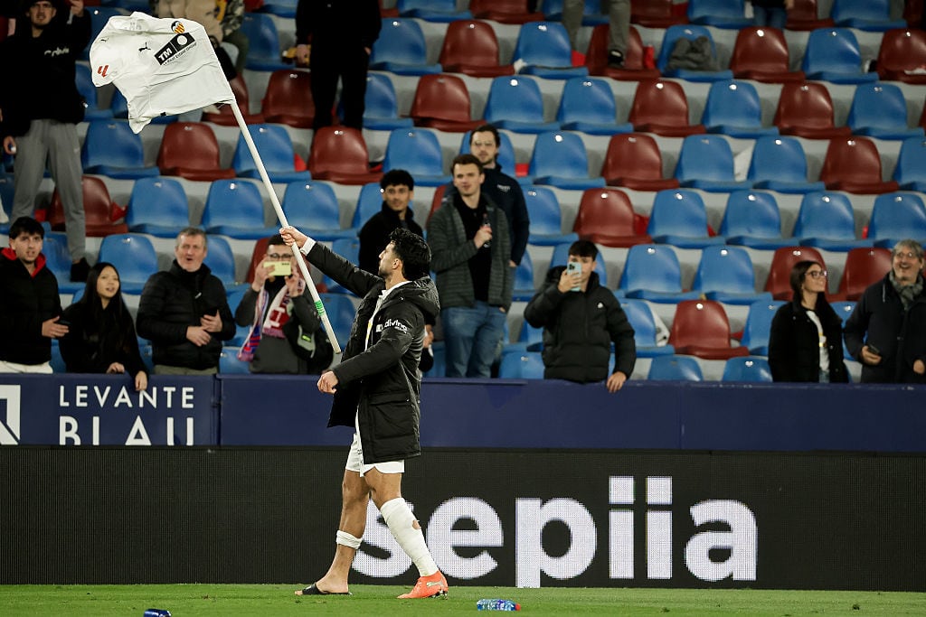 Eray Comert of Valencia CF provokes the Levante fans and players at the end of the match by placing his shirt on the corner flag during the LaLiga match between Levante UD and Valencia CF at Ciutat de Valencia Stadium in Valencia, Spain, on February 15, 2026. (Photo by Jose Miguel Fernandez/NurPhoto via Getty Images)