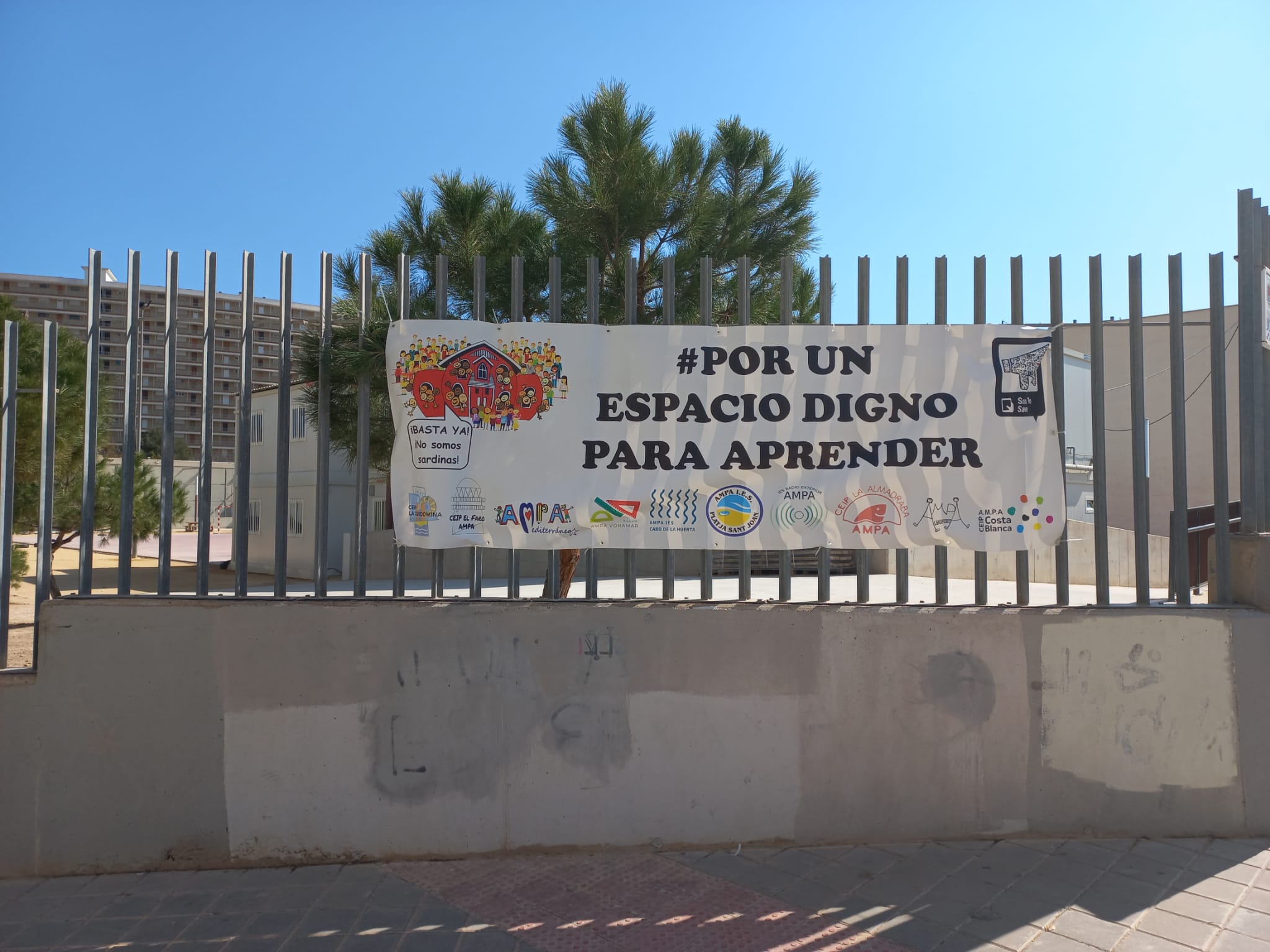 Cartel reivindicativo en el exterior del patio que acoge los barracones del CEIP La Almadraba de Alicante