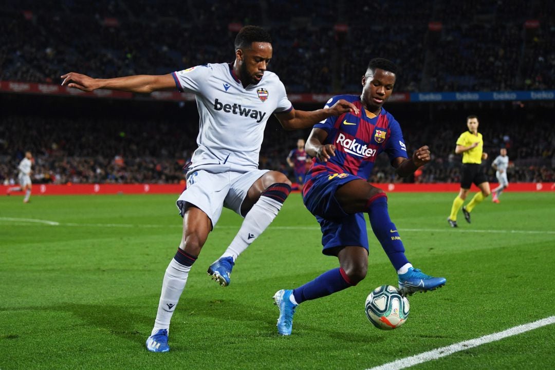 Ansu Fati of FC Barcelona tackles with Hernani Fortes of Levante UD during the Liga match between FC Barcelona and Levante UD at Camp Nou 