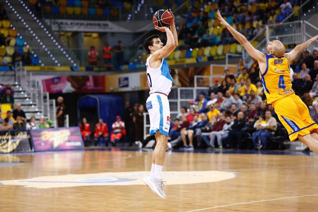 David Navarro lanza a canasta en el Gran Canaria Arena, ante la oposición de Albert OIiver