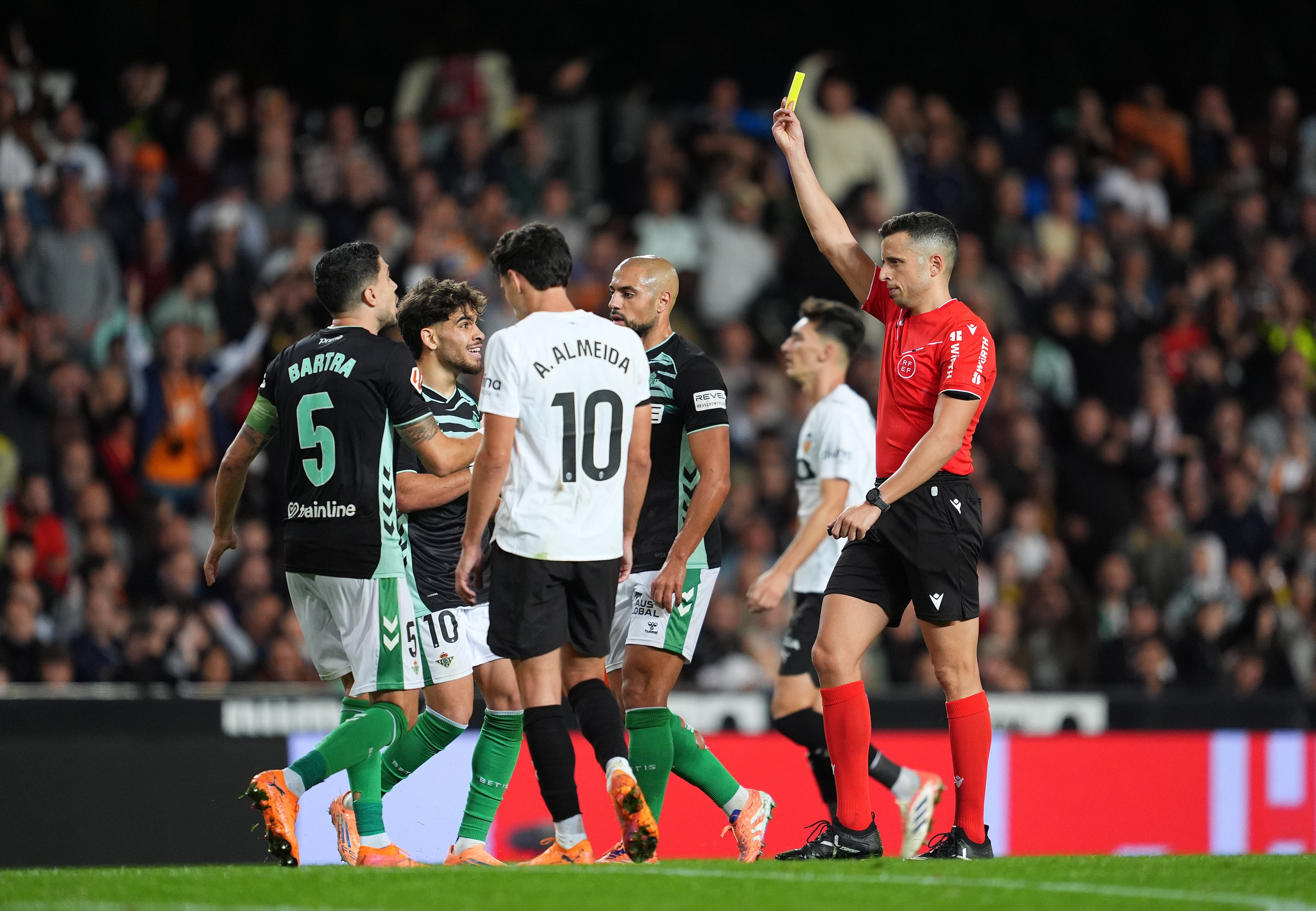 Víctor García Verdura sacando una tarjeta amarilla